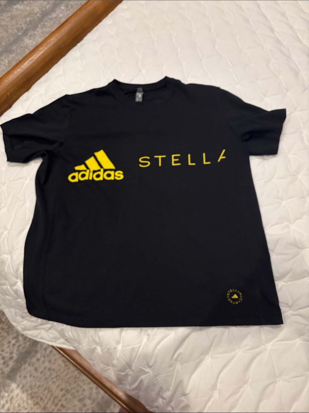 Women’s Stella McCartney adidas Black Short-Sleeve Tee with Yellow Logo.
